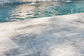 Natural Stone vs. 2CM Porcelain Pavers for Pool Decks: A Hardscape Expert’s Guide